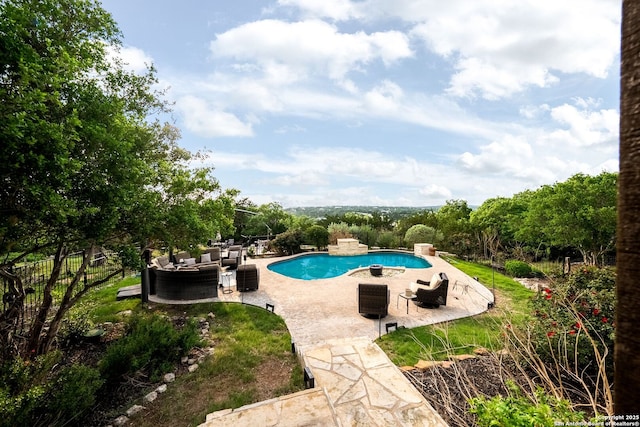 outdoor pool with an outdoor hangout area and a patio area