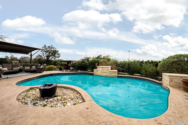 outdoor pool featuring fence and an outdoor hangout area