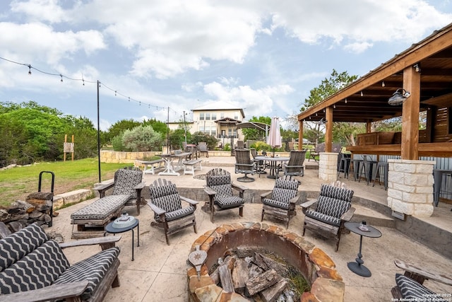 view of patio / terrace with an outdoor fire pit and outdoor dry bar