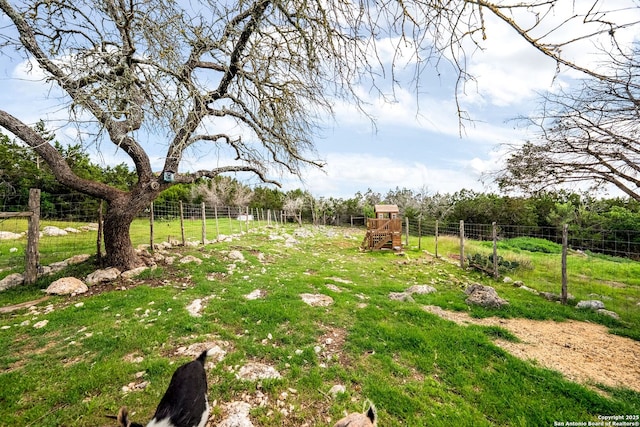 view of yard featuring fence and a playground