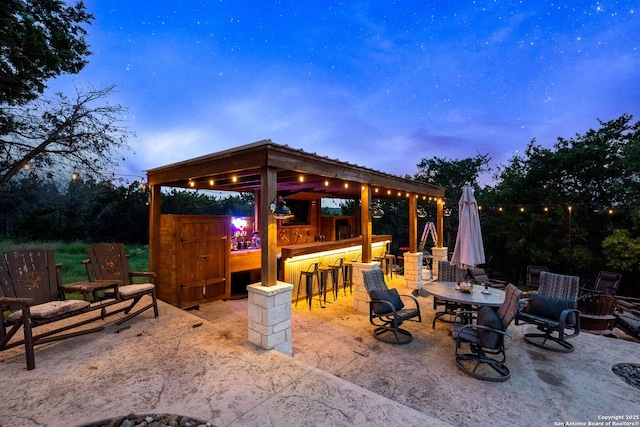 view of patio with outdoor dry bar and a gazebo