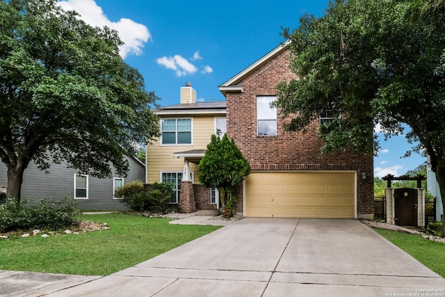traditional home with concrete driveway, a front yard, brick siding, and a garage