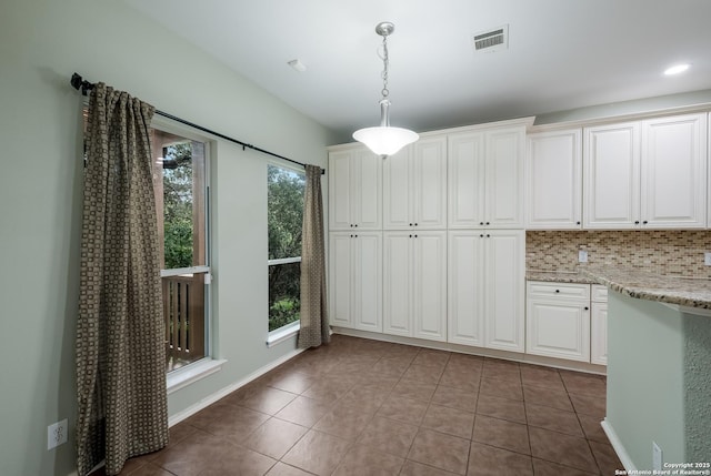 unfurnished dining area featuring light tile patterned floors and visible vents
