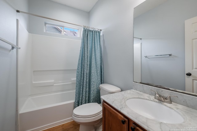 full bath featuring shower / bath combo with shower curtain, toilet, wood finished floors, and vanity