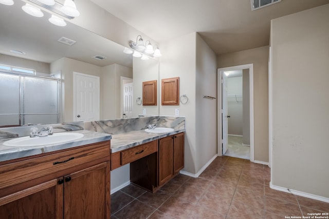 full bath with a sink, a shower stall, and visible vents
