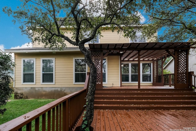 back of property with a pergola and a wooden deck