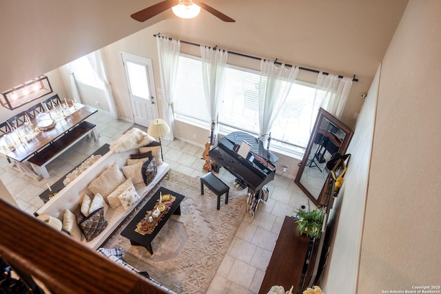 8701 Stackstone, Schertz, TX 78154 - living area featuring tile patterned flooring, ceiling fan, vaulted ceiling, and baseboards