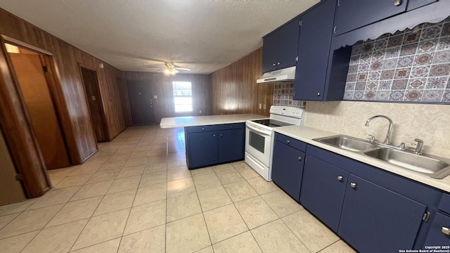 17 Fm 473, Comfort, TX 78013 - kitchen with ceiling fan, under cabinet range hood, blue cabinetry, electric stove, and a peninsula