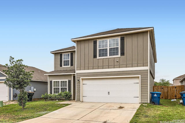 traditional home with fence, board and batten siding, a front yard, and concrete driveway