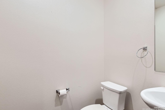 bathroom with toilet and a sink