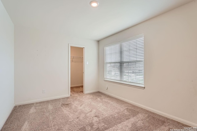carpeted empty room with baseboards
