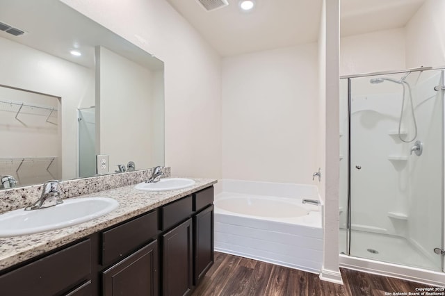 bathroom with visible vents, a stall shower, and a sink