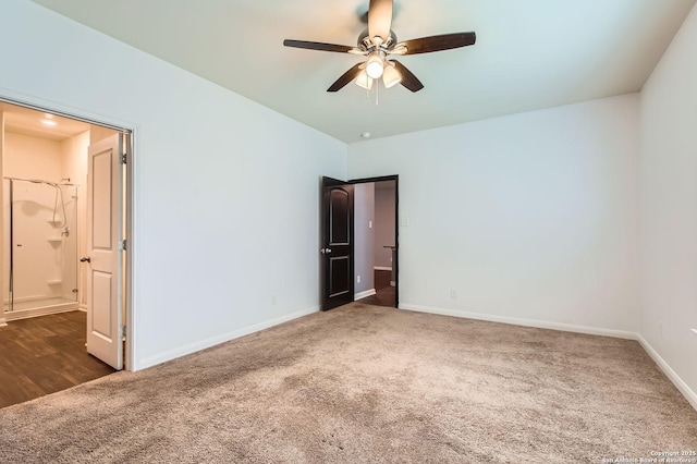 unfurnished bedroom featuring ensuite bathroom, carpet flooring, and baseboards