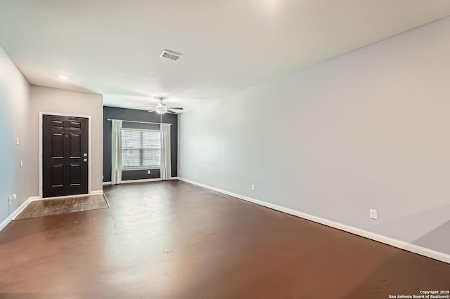 interior space featuring ceiling fan, finished concrete floors, visible vents, and baseboards