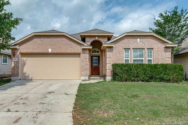 8355 Lazy Pebble, San Antonio, TX 78254 - ranch-style house with concrete driveway, a front yard, brick siding, and a garage