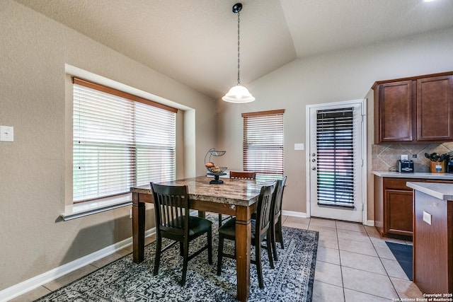 8355 Lazy Pebble, San Antonio, TX 78254 - dining space featuring lofted ceiling, a wealth of natural light, light tile patterned floors, and baseboards