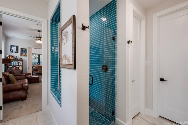 bathroom with ceiling fan, a shower stall, marble finish floor, and baseboards