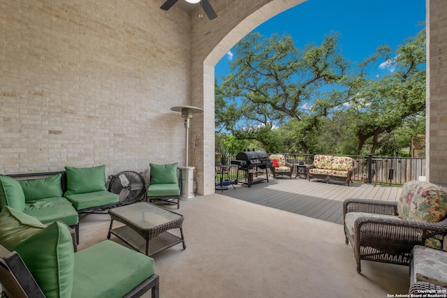 view of patio / terrace with outdoor lounge area, a ceiling fan, a wooden deck, and area for grilling