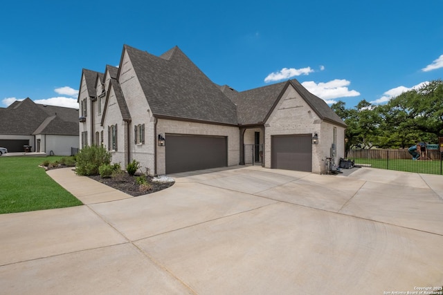 view of side of property featuring concrete driveway, a shingled roof, fence, brick siding, and a garage