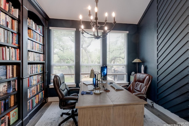 office featuring wood finished floors and an inviting chandelier