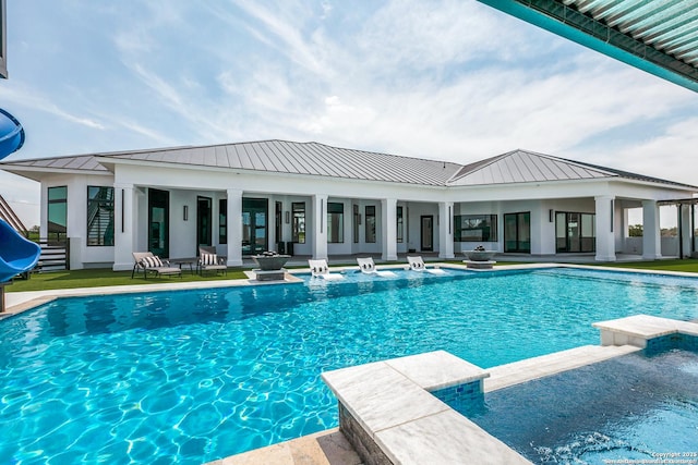 view of swimming pool featuring a pool with connected hot tub and a patio area