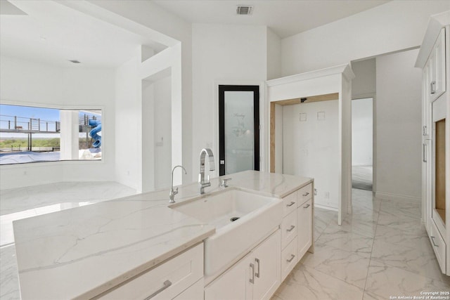 bathroom with visible vents, marble finish floor, and vanity