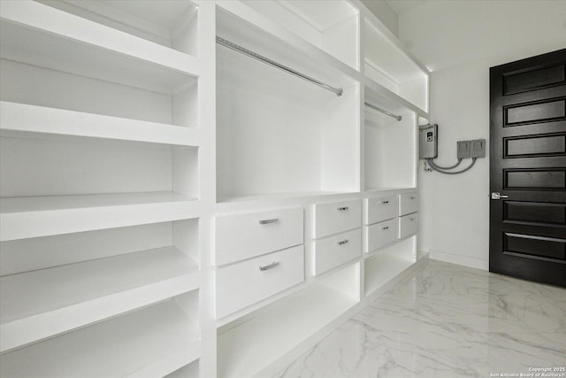 spacious closet featuring marble finish floor