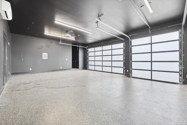 garage with baseboards and a wall unit AC