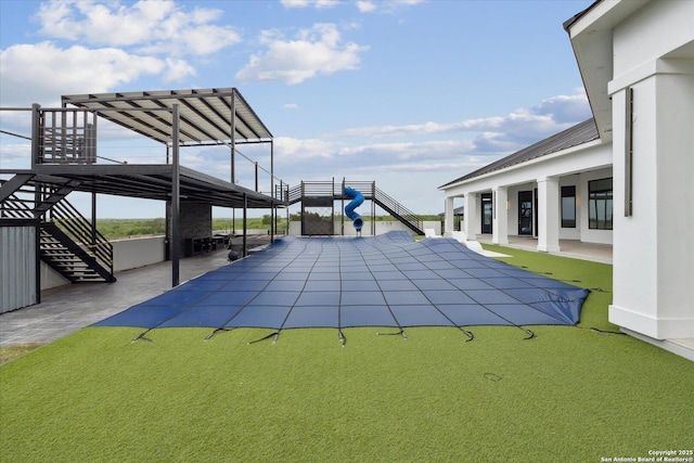 view of swimming pool featuring stairs and a patio area