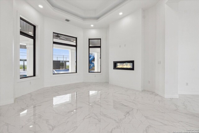 spare room featuring recessed lighting and marble finish floor