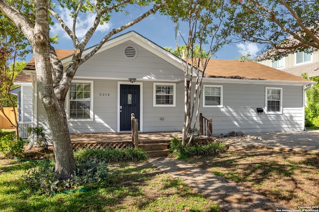 bungalow-style home with a shingled roof