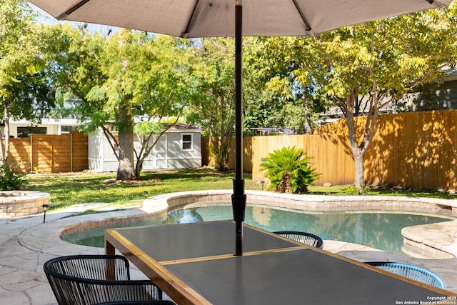 view of pool featuring a fenced in pool, an outbuilding, and a fenced backyard