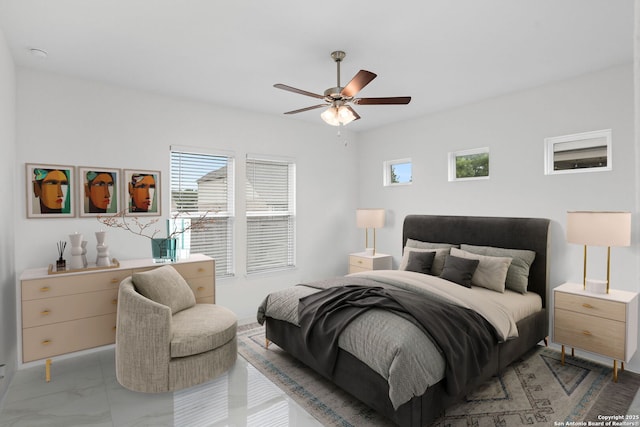 bedroom with a ceiling fan and marble finish floor