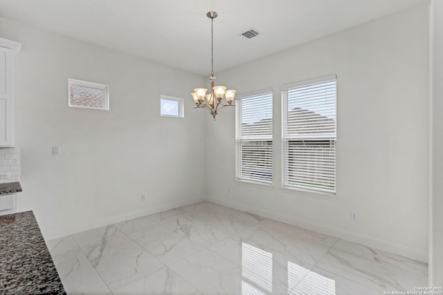 unfurnished dining area with baseboards, visible vents, and marble finish floor