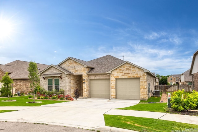 view of front facade featuring a garage, fence, a front yard, and driveway