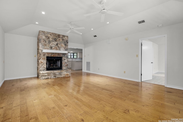unfurnished living room featuring lofted ceiling, visible vents, and ceiling fan