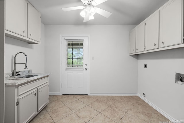 washroom with cabinet space, light tile patterned flooring, hookup for an electric dryer, and a sink