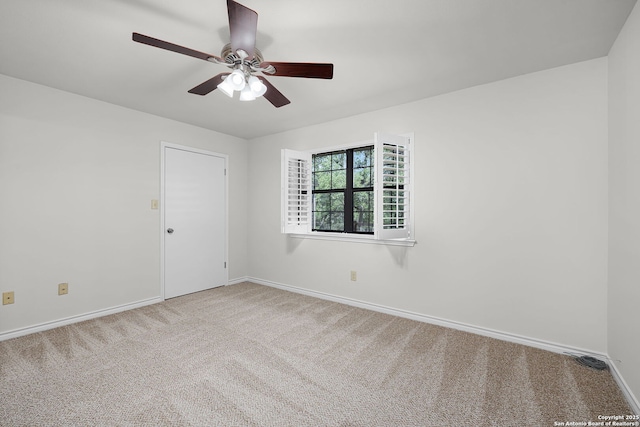 unfurnished room featuring carpet flooring, ceiling fan, and baseboards