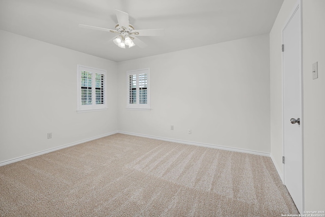empty room featuring a ceiling fan, carpet flooring, and baseboards