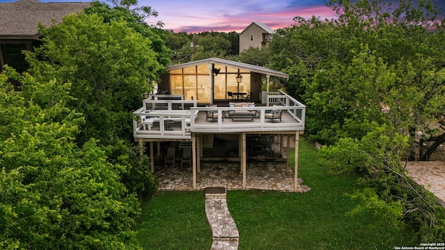 back of house with a deck, a yard, and outdoor dining area