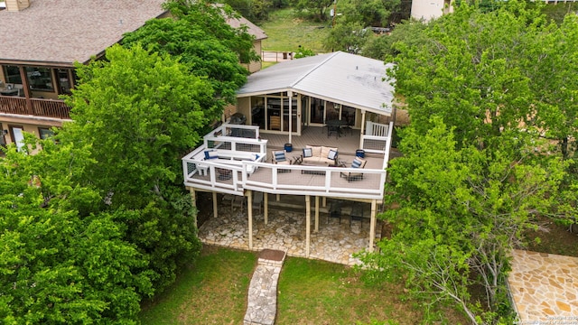 back of property featuring a deck, outdoor dining area, and outdoor lounge area