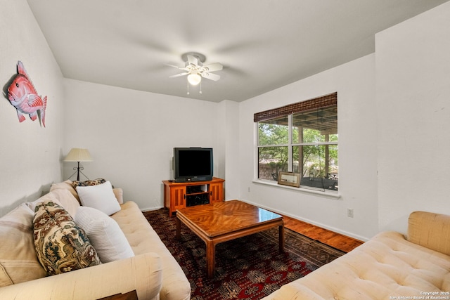 living area featuring ceiling fan, wood finished floors, and baseboards