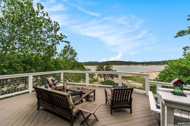 wooden terrace with outdoor lounge area and a water view