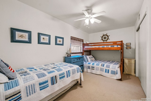 carpeted bedroom with a closet and ceiling fan