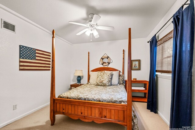 carpeted bedroom featuring visible vents, a ceiling fan, and baseboards