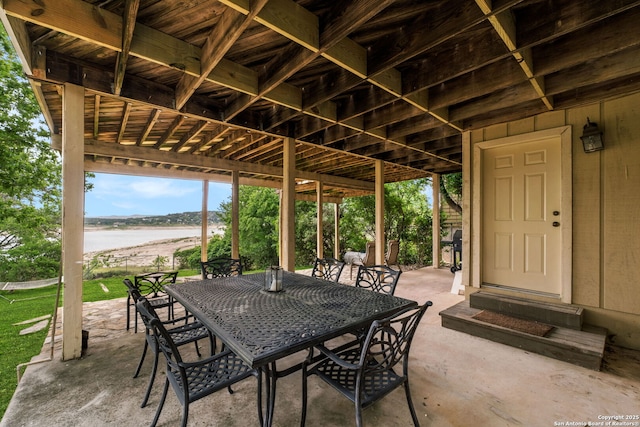 view of patio / terrace featuring outdoor dining area and a water view