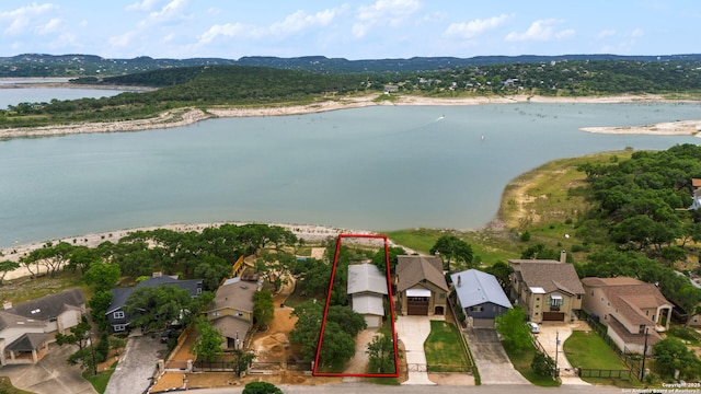 birds eye view of property with a water view and a residential view