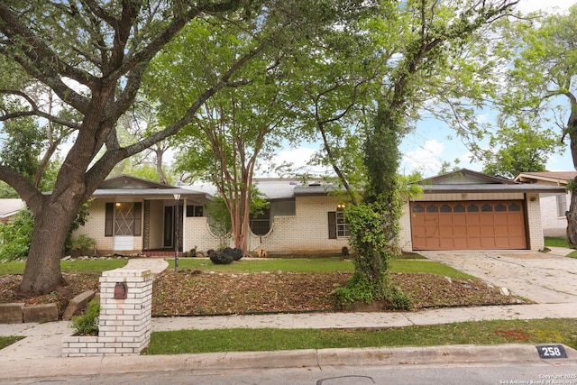 ranch-style home with concrete driveway, an attached garage, and brick siding