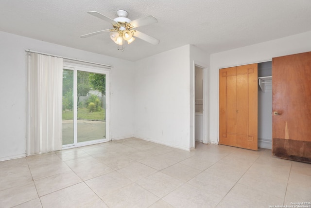 unfurnished bedroom with light tile patterned floors, a closet, access to exterior, a ceiling fan, and a textured ceiling