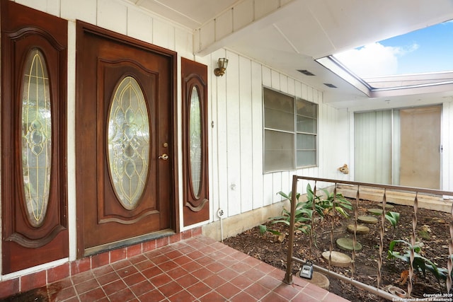 view of exterior entry with a porch